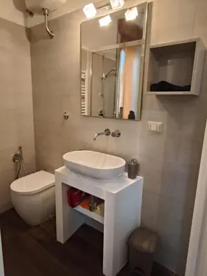 a bathroom with a sink and a toilet and a mirror at Roma Eur - OrangeVibes Loft in Rome
