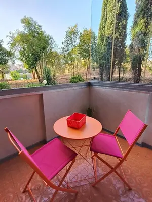 two chairs and a table with a red box on it at Roma Eur - OrangeVibes Loft in Rome