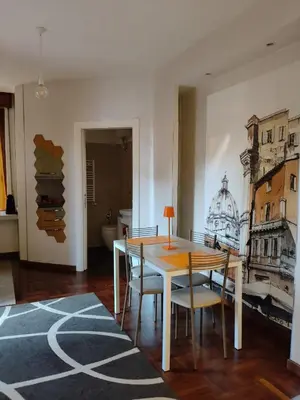 a dining room with a wooden table and chairs at Roma Eur - OrangeVibes Loft in Rome