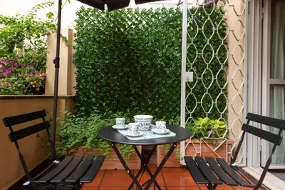 a table with cups and saucers on a patio at My Spanish Steps Apartment - 2 bathrooms in Rome