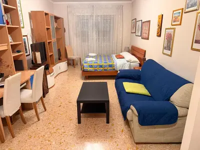 a bedroom with pink walls and a bed and a table at Suite Porta Portese in Rome