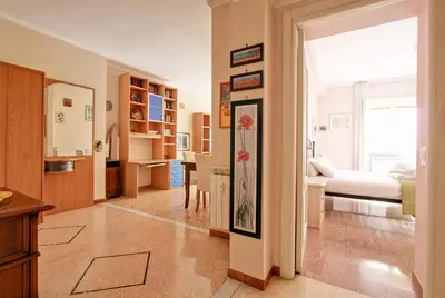a living room with a bedroom and a bed at Suite Porta Portese in Rome