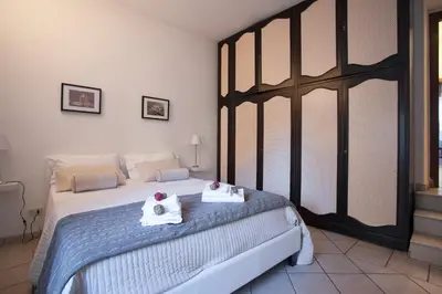 a bedroom with a bed with two towels on it at Magenta Luxury Purificazione in Rome