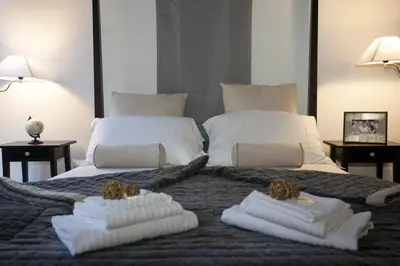 a large bed with two white towels on it at Magenta Luxury Purificazione in Rome