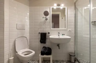 a white bathroom with a toilet and a sink at CASA VACANZA San LO' ZONA SAN LORENZO TERMINI ROMA in Rome