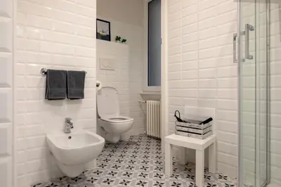 a white bathroom with a toilet and a sink at CASA VACANZA San LO' ZONA SAN LORENZO TERMINI ROMA in Rome