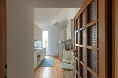a kitchen with a door leading to a dining room at iFlat Pantheon Peaceful & Comfortable Apartment in Rome