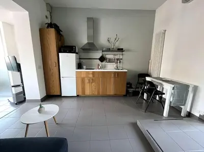 a kitchen with a refrigerator and a table in a room at Casa Vivi in Rome