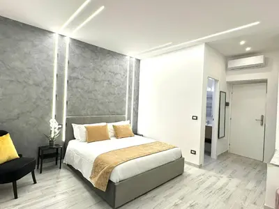 a bedroom with a bed and a chair in it at Turati Inn in Rome