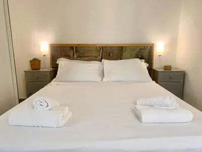 a bedroom with a bed with two towels on it at DaliTourism - Vatican Apartment 118 in Rome