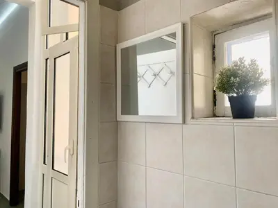 a bathroom with a mirror and a window at DaliTourism - Vatican Apartment 118 in Rome