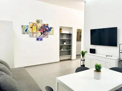 a living room with a tv and a table at DaliTourism - Vatican Apartment 118 in Rome