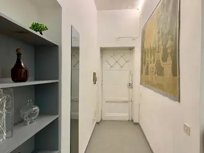 a hallway with a white door and a painting on the wall at DaliTourism - Vatican Apartment 118 in Rome