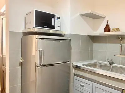 a kitchen with a stainless steel refrigerator and a microwave at DaliTourism - Vatican Apartment 118 in Rome