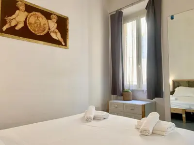 a bedroom with a bed with towels on it at DaliTourism - Vatican Apartment 118 in Rome