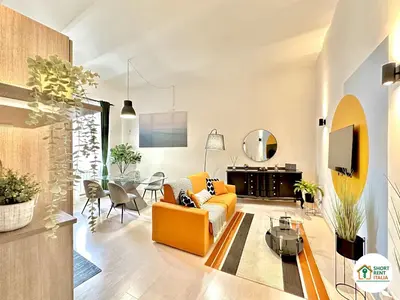 a living room with a yellow couch and a table at Corso Francia - Exclusive House in Rome