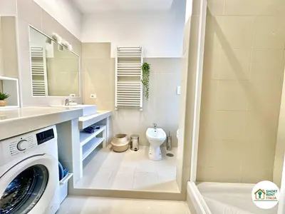a bathroom with a washing machine and a toilet at Corso Francia - Exclusive House in Rome