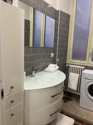 a bathroom with a sink and a washing machine at Nicky's House in Rome