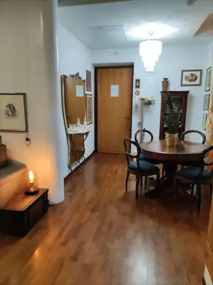 a living room with a table and chairs and a dining room at Colosseo Vintage Apartment in Rome