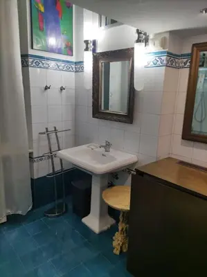 a bathroom with a sink and a mirror at Colosseo Vintage Apartment in Rome