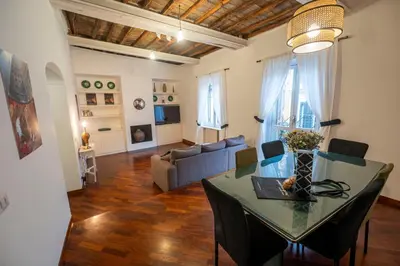 a living room with a table and a couch at Pantheon Terrace 2 BR Apartment in Rome