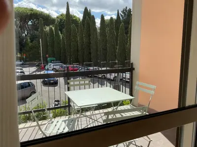 a table and chairs on a balcony with a parking lot at Vatican New home in Rome in Rome