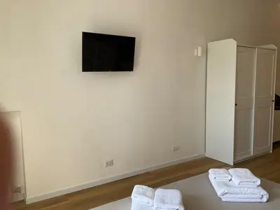 a room with two white towels and a tv on a wall at Vatican New home in Rome in Rome