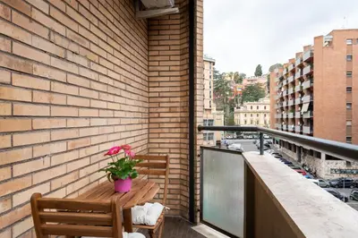 a balcony with a bench and a potted plant at Your Place in Trastevere in Rome