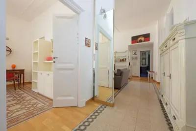a hallway with a door and a chair in a room at Parioli, Bright And Quiet 2BR Apartment By Halldis in Rome