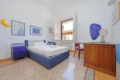 a bedroom with a bed and a desk in it at Parioli, Bright And Quiet 2BR Apartment By Halldis in Rome