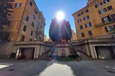 a building with stairs in the middle of two buildings at Parioli, Bright And Quiet 2BR Apartment By Halldis in Rome