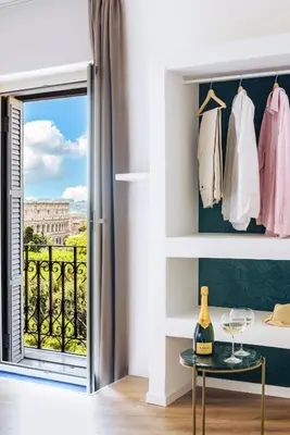 a room with a door open to a balcony at Elysium Suites Colosseo in Rome