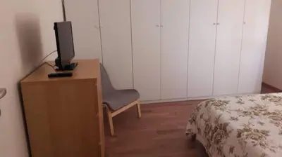 a bedroom with a desk with a tv and a chair at ISABEL Apartment in Rome