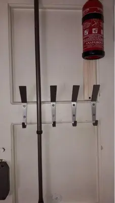 a red pot on a shelf above a white refrigerator at ISABEL Apartment in Rome
