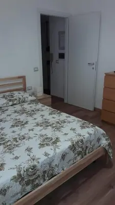 a bedroom with a bed with a floral bedspread at ISABEL Apartment in Rome