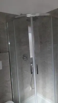 a shower with a glass door in a bathroom at ISABEL Apartment in Rome