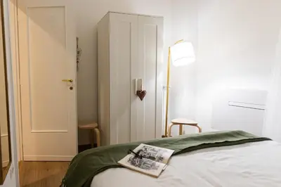 a bedroom with a bed with a book on it at Casa Margherita in Rome