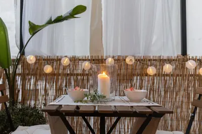 a candle on a table with bowls and candles at Casa Margherita in Rome