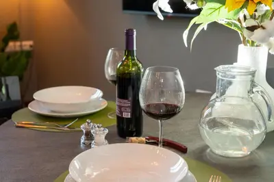 a bottle of wine and a glass on a table at CupolHome - Meraviglia A San Pietro in Rome