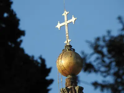 a cross on the top of a tower with a ball at CupolHome - Meraviglia A San Pietro in Rome
