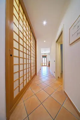a hallway with a door and a tiled floor at Domus Mariposa in Rome