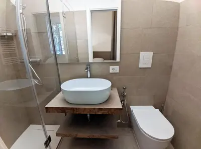 a bathroom with a sink and a toilet and a shower at Astom Suites in Rome