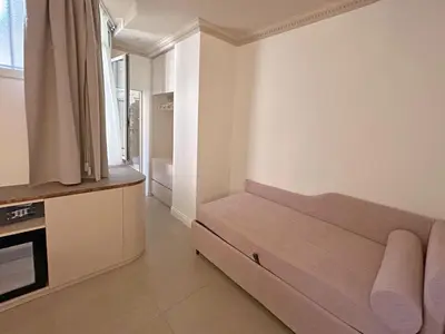 a room with a bed in the corner of a room at Astom Suites in Rome