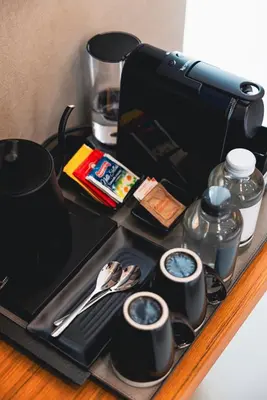 a tray with cups and utensils on a table at J Maluni City Hotel in Rome