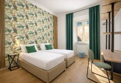 a hotel room with two beds and a wall mural at Ciao Collection in Rome