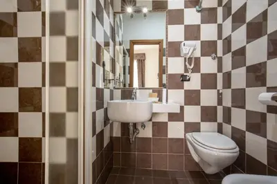 a hotel room with two beds and a mirror at Ciao Collection in Rome