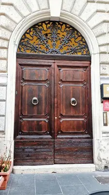 a large wooden door in a building at Ciao Collection in Rome
