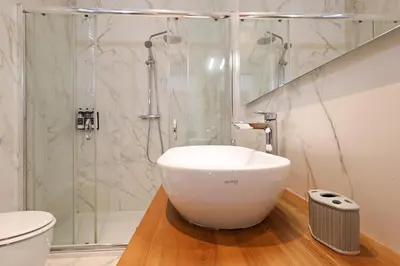a bathroom with a large white sink and a shower at Zelo Apartment by Nosdom Properties in Rome