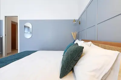 a bedroom with a large white bed with pillows at Zelo Apartment by Nosdom Properties in Rome