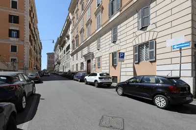 a street with cars parked on the side of a building at Zelo Apartment by Nosdom Properties in Rome